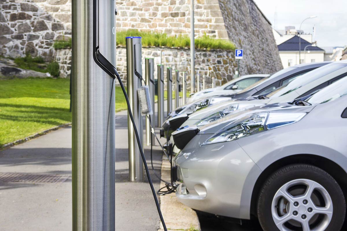 cars-charging-in-lot-stone-wall