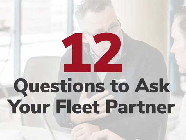 12 Questions to Ask Your Fleet Partner" text over blurred image of two people conversing.