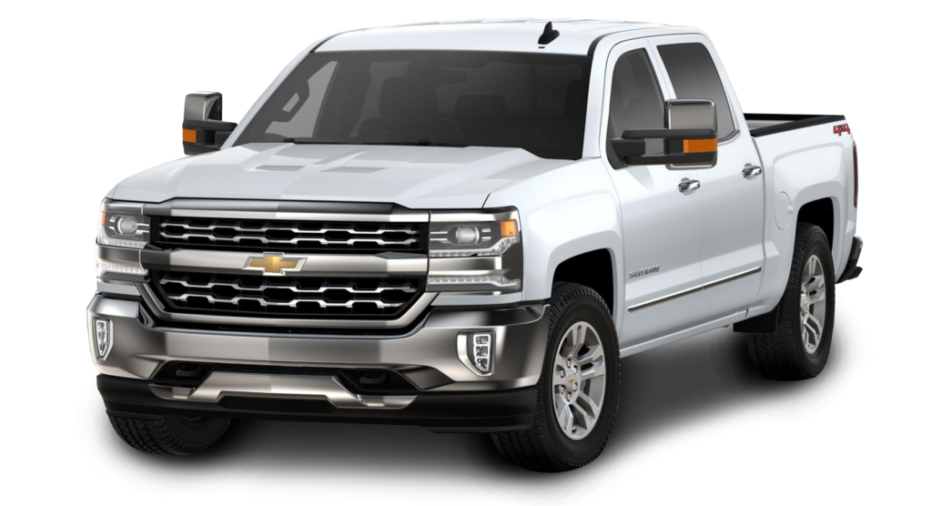 White Chevrolet pickup truck with chrome detailing and extended mirrors, viewed from the front at an angle.