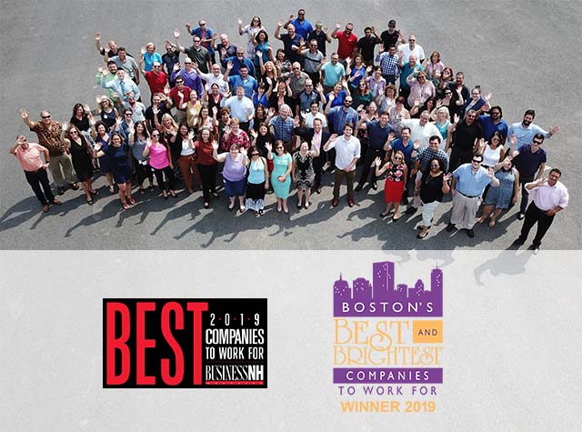 A large group of people standing together, celebrating "Best Companies to Work For" awards in 2019.