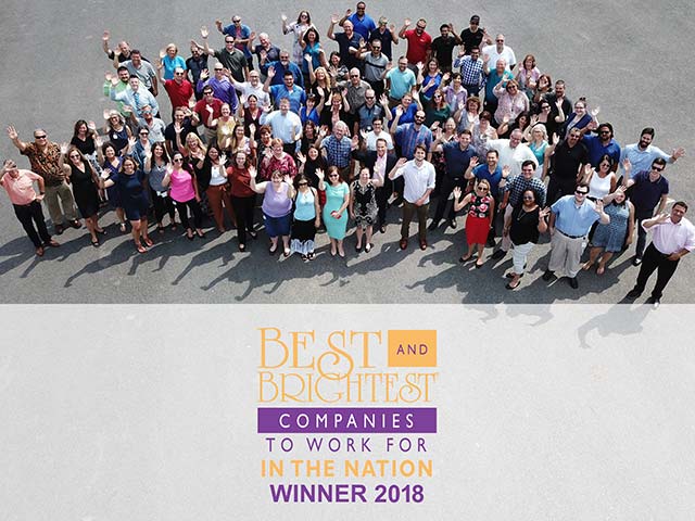 Aerial view of a large group of people standing together, with a "Best and Brightest Companies" award banner below.