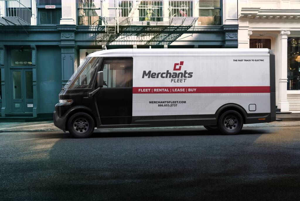 Electric delivery van parked on a city street, branded with "Merchants Fleet" and rental service details.