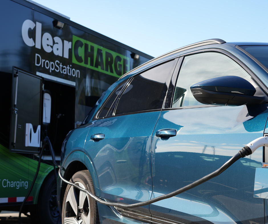 Electric car charging at a ClearCharger DropStation, with a cable connected to the vehicle.