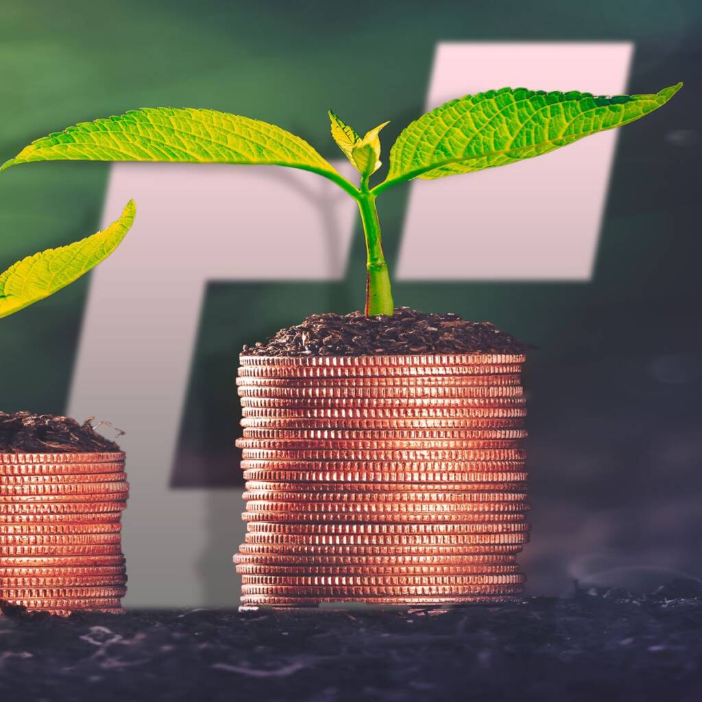 Small plant growing from stacked coins against a blurred background, symbolizing financial growth or investment.