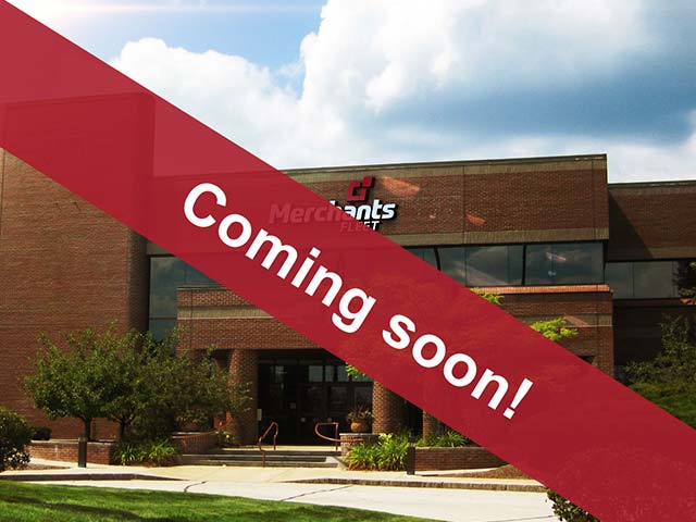 Brick building with "Merchants Fleet" logo, covered with a red banner reading "Coming soon!".