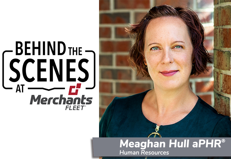 Woman with short hair, wearing a dark top, stands near a brick wall. Text: "Behind the Scenes at Merchants Fleet.