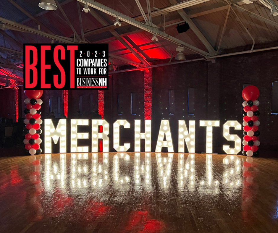 Large illuminated "MERCHANTS" sign with red and black balloons; "Best Companies to Work For 2023" banner above.