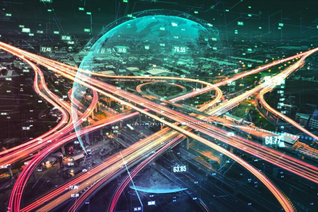Futuristic cityscape with neon-lit highways intersecting under a digital globe overlay.
