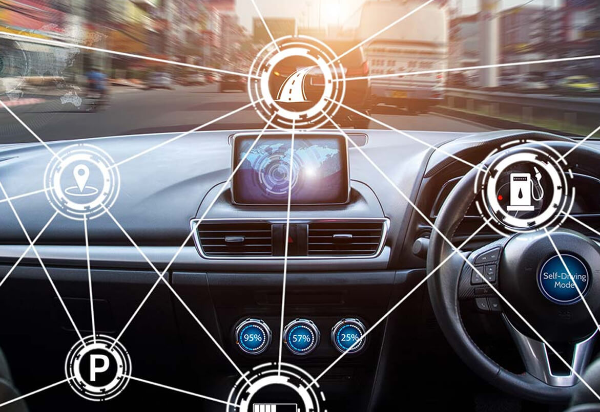 View from a car dashboard with digital navigation icons and self-driving mode interface overlaid on the windshield.