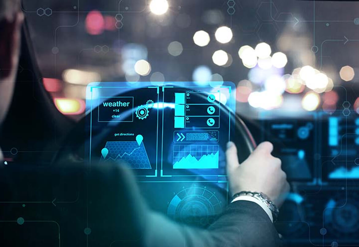 Person driving car with a futuristic digital dashboard displaying weather and navigation information.