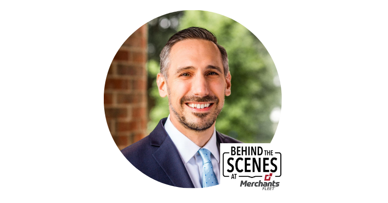 Smiling man in a suit with short hair and beard, overlaid with "Behind the Scenes at Merchants Fleet" logo.