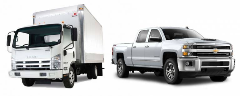 A white box truck and a white pickup truck side by side on a plain background.